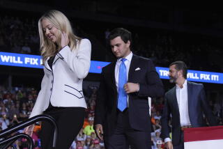 Tiffany Trump and her husband Michael Boulos leave the stage at a rally in Grand Rapids, Mich.