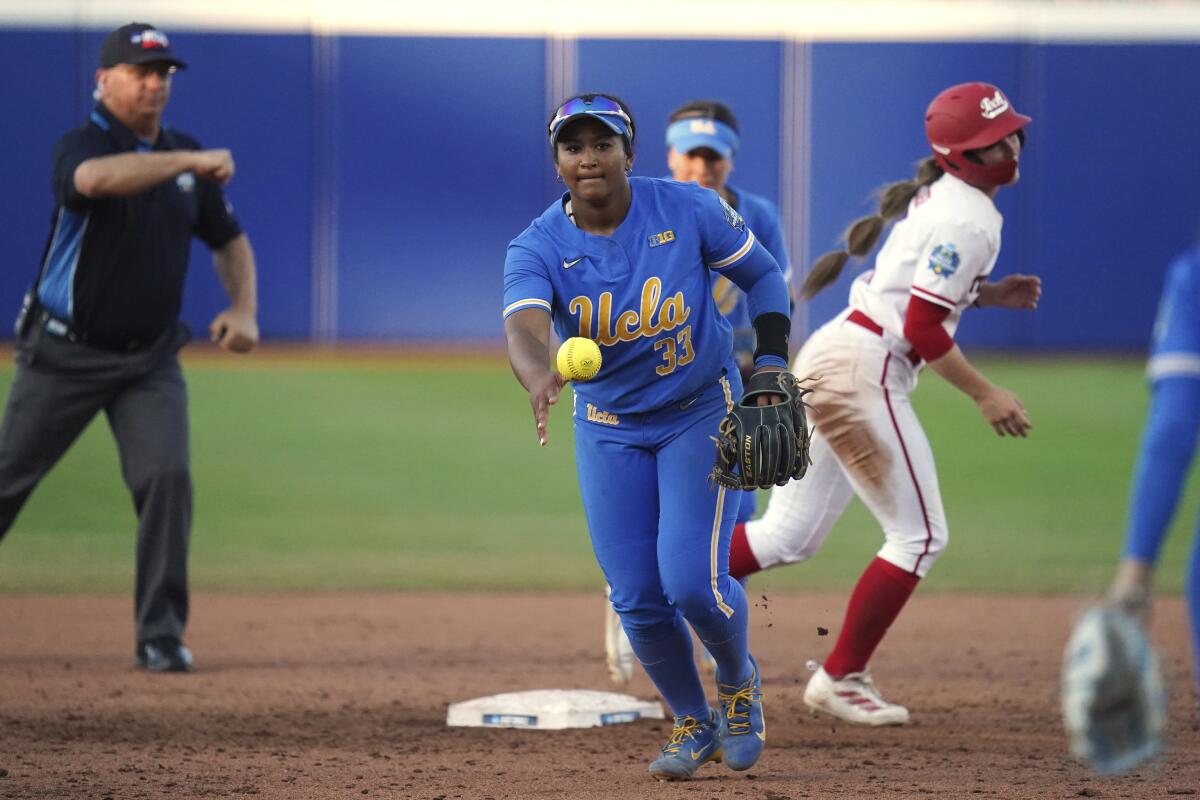 UCLA infielder Kaniya Bragg tosses the ball after forcing out a runner at second base.