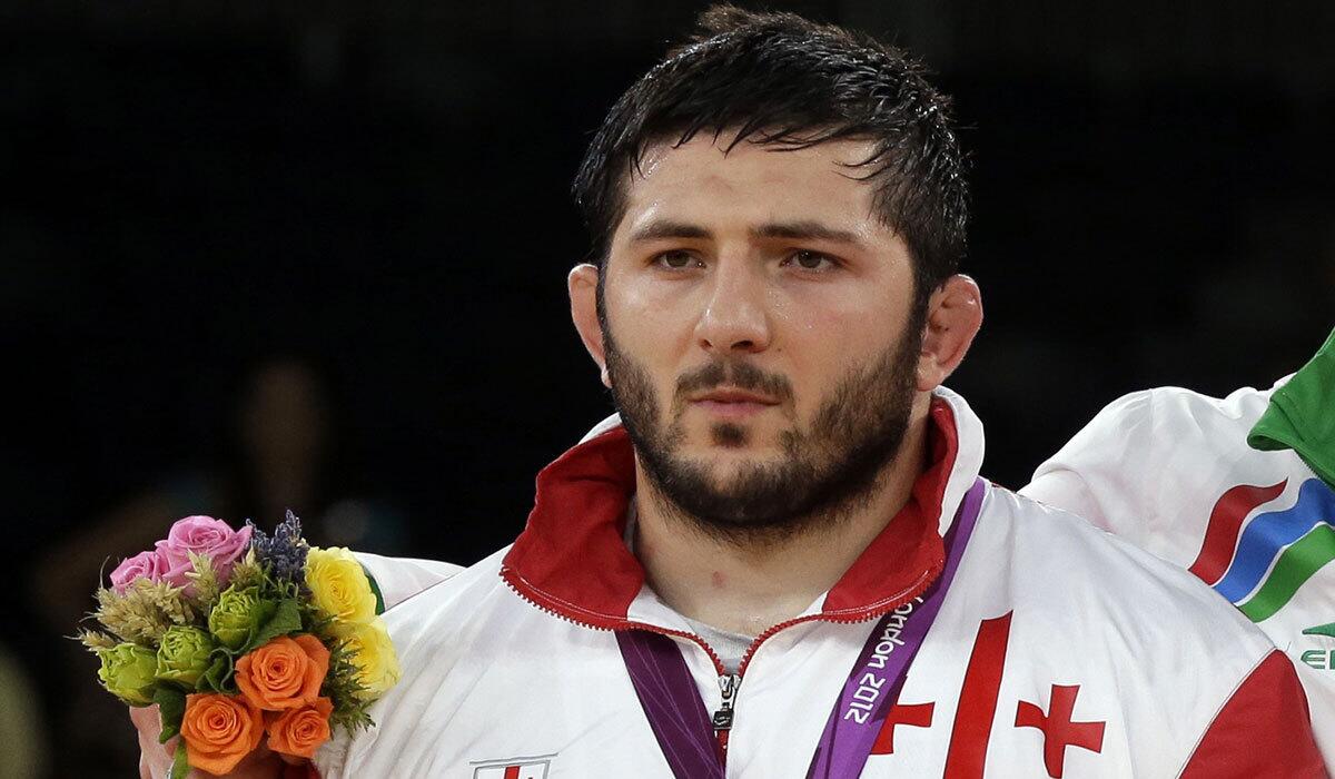 Davit Modzmanashvili of Georgia poses with his silver medal during the medals ceremony for the men's 120-kilogram freestyle wrestling competition, held on Aug. 11, 2012, at the Summer Olympics in London.