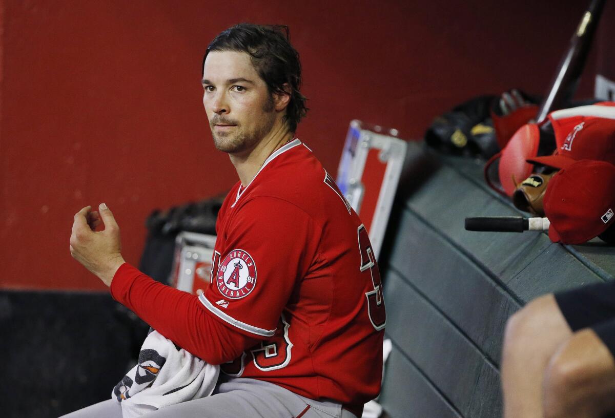 Angels starting pitcher C.J. Wilson sits in the dugout during the third inning of a game against the Diamondbacks on June 18, 2015..