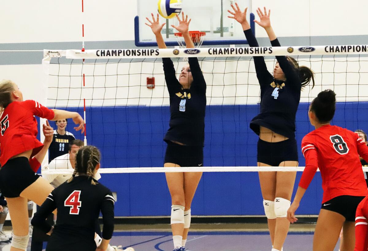 Marina's Jordan Packer (9) and Jenna Zaffino jump for a block in a girls' volleyball championship match at Cerritos College.