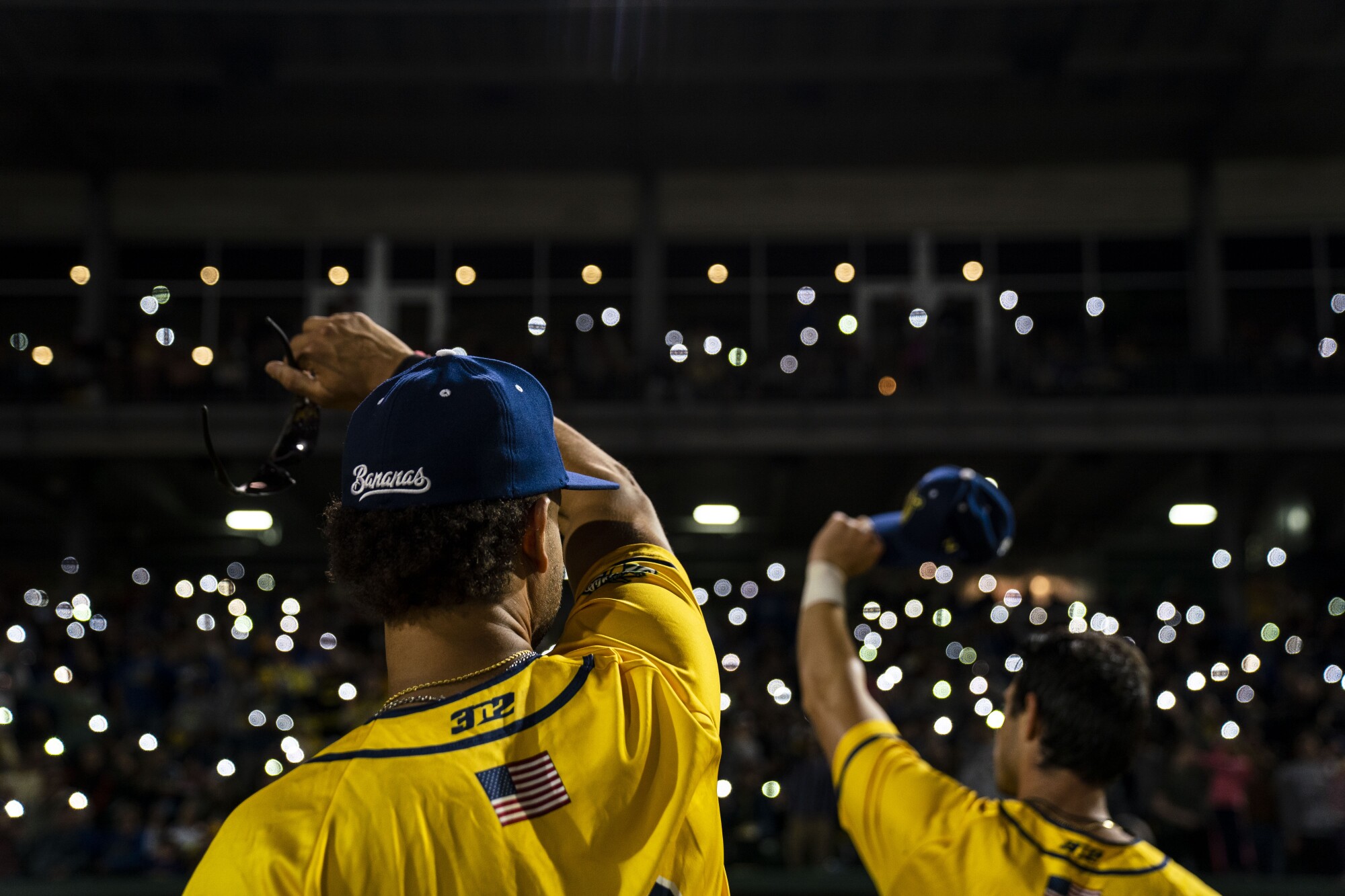 During the seventh inning, Savannah Bananas fans wave their cellphones during the playing of Coldplay's 