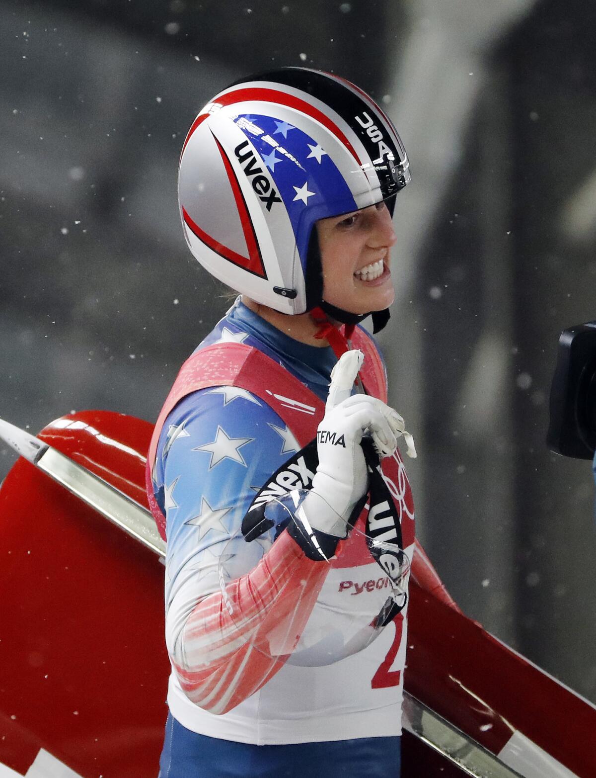 Emily Sweeney of the United States waves after her third run during the women's luge final on Tuesday.