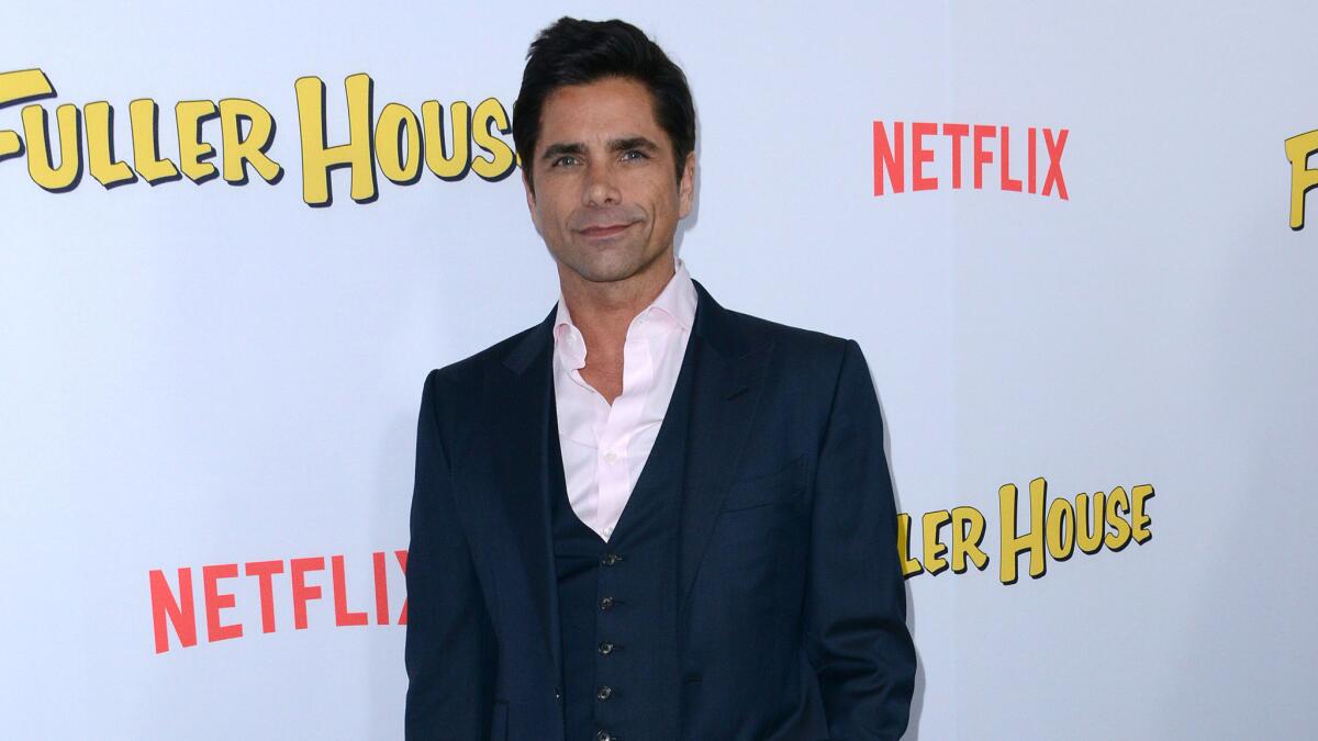 John Stamos arrives for the premiere of "Fuller House" in Los Angeles on Feb. 16.