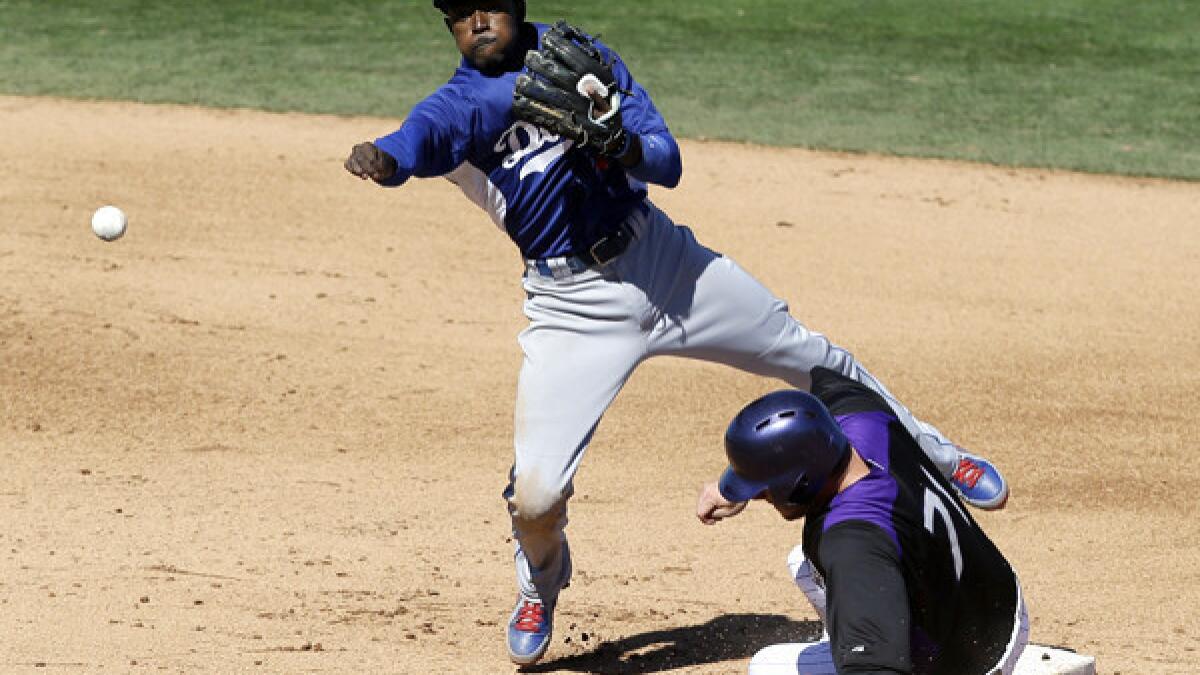 Los Angeles Dodgers second baseman Dee Gordon (L) and manager Don