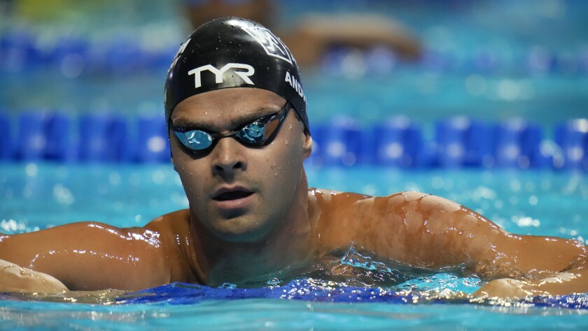Michael Andrew in the pool after swimming a 50-meter race.