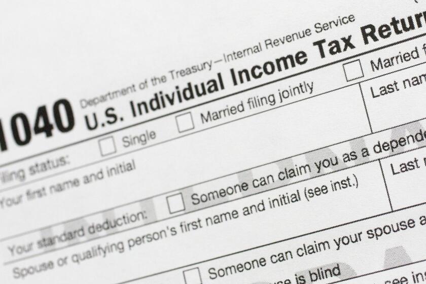 FILE - A portion of the 1040 U.S. Individual Income Tax Return form is shown July 24, 2018, in New York. Taxpayers will get fatter standard deductions for 2023 and all seven federal income tax bracket levels will be revised upward as the government allows people to shield more of their money from taxation because of persistently high inflation. For couples who file jointly for tax year 2023, the standard deduction increases to $27,700 up $1,800 from tax year 2022, the IRS announced. (AP Photo/Mark Lennihan, File)