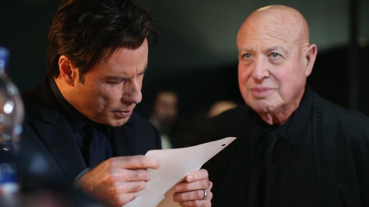 Paul Bloch, right, backstage with John Travolta at the 2014 Oscars, when the actor famously flubbed his intro of Idina Menzel. Damage control was part of Bloch's job.