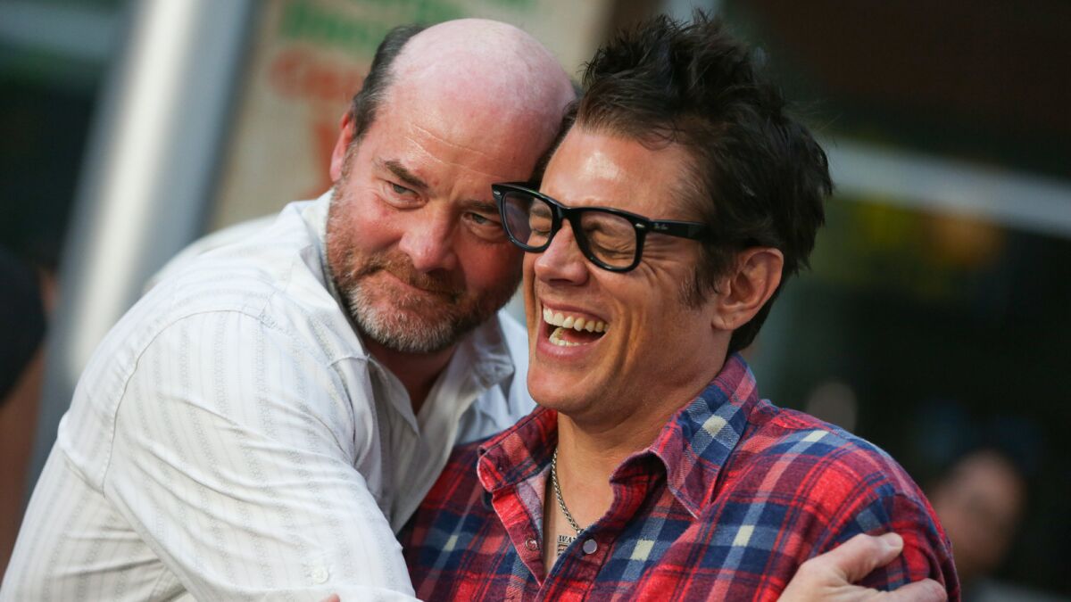 David Koechner, left, and Johnny Knoxville arrive at the Los Angeles premiere of "Being Evel" in Los Angeles.