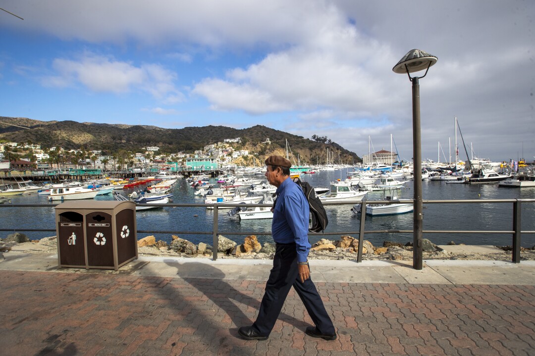 David Sanchez walks past boats in the marina at Catalina Island