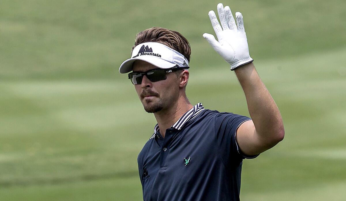Rikard Karlberg acknowledges the cheers from the spectators during the first round of the CIMB Classic in Malaysia on Thursday.