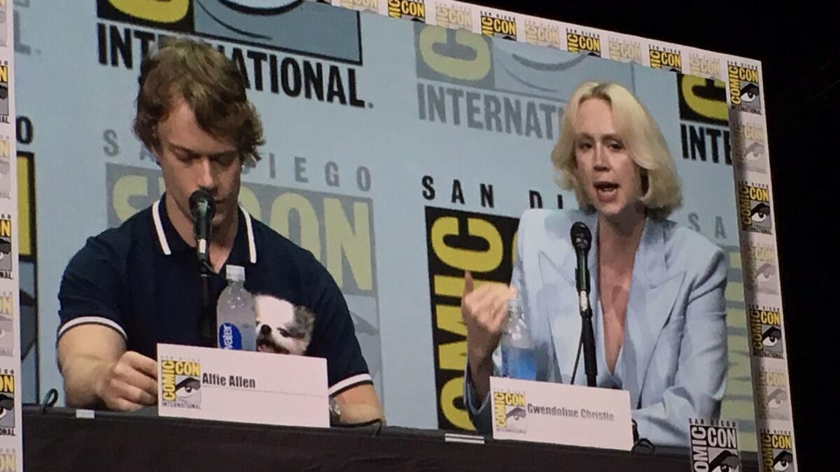 Alfie Allen (Theon Greyjoy), his dog, and Gwendoline Christie (Brienne of Tarth) at the"'Game of Thrones" panel at Comic-Con Friday.