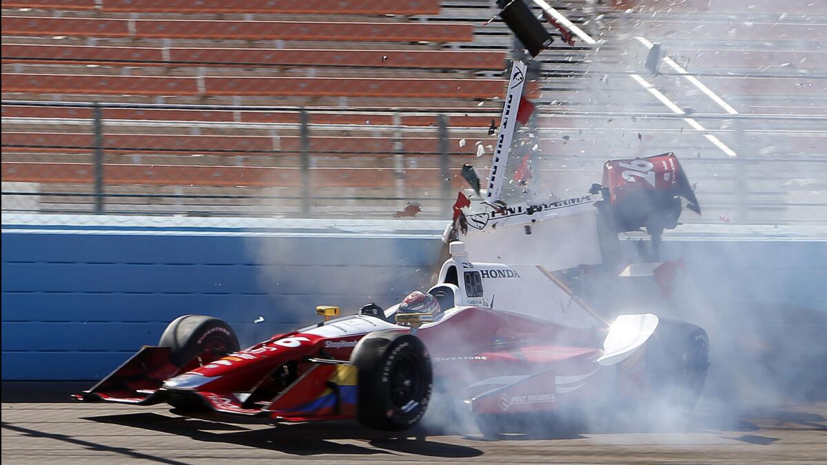 IndyCar driver Carlos Munoz takes a turn during a pracatice run at Phoenix International Raceway on Friday.