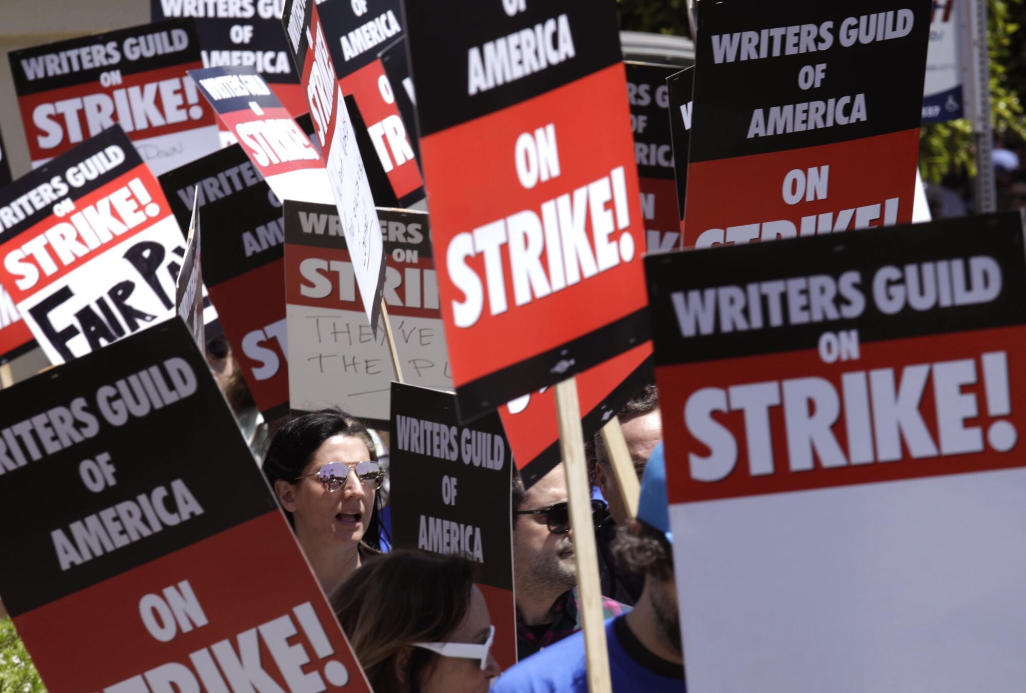 WGA members walk the picket line on the first day of their strike in front of Paramount Studios in Hollywood