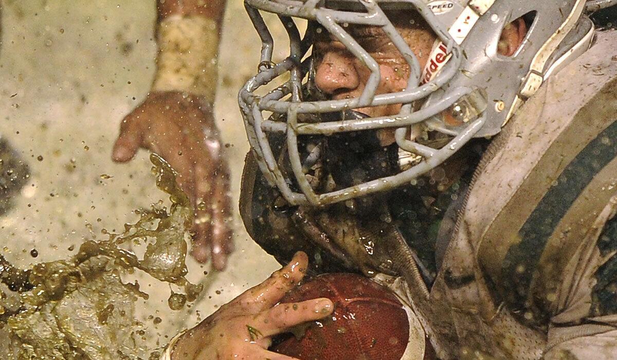 De La Salle 's Lucas Dunne is tackled during the second half of the wet and muddy CIF Open Division championship game against Servite on Dec. 18, 2010, in Carson.