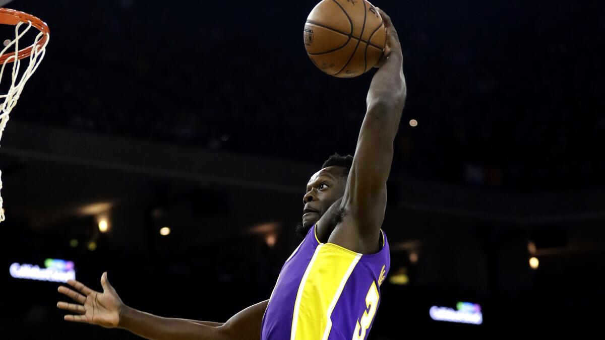 Lakers forward Julius Randle elevates for a dunk against the Warriors during the first half Friday night.