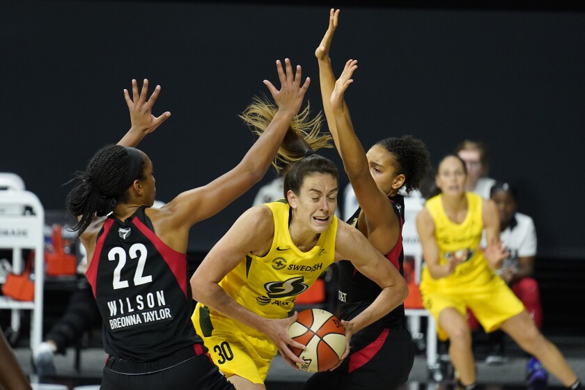 FILE - Seattle Storm forward Breanna Stewart (30) gets between Las Vegas Aces center A'ja Wilson (22) and forward Cierra Burdick (11) during the second half of Game 3 of basketball's WNBA Finals in Bradenton, Fla., in this Tuesday, Oct. 6, 2020, file photo. The WNBA will tip off its 25th season on Friday, May 14, 2021. (AP Photo/Chris O'Meara)