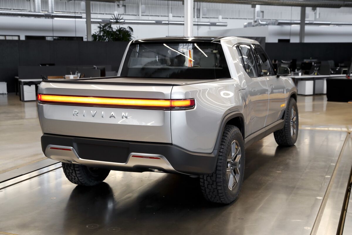 FILE - This Nov. 14, 2018, file photo shows a Rivian R1T at Rivian headquarters in Plymouth, Mich. Shares in Rivian Automotive are set to trade publicly on Wednesday, Nov. 10, 2021, and the world should get a better idea of just how hot investors are for the electric vehicle market. (AP Photo/Paul Sancya, File)