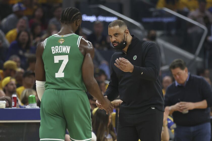 Boston Celtics guard Jaylen Brown (7) talks with head coach Ime Udoka during the first half of Game 1 of basketball's NBA Finals against the Golden State Warriors in San Francisco, Thursday, June 2, 2022. (AP Photo/Jed Jacobsohn)