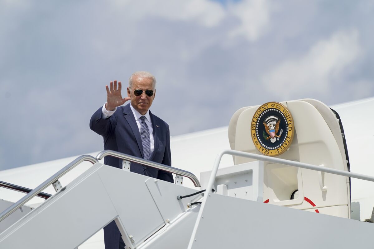 President Biden waves before boarding Air Force One.