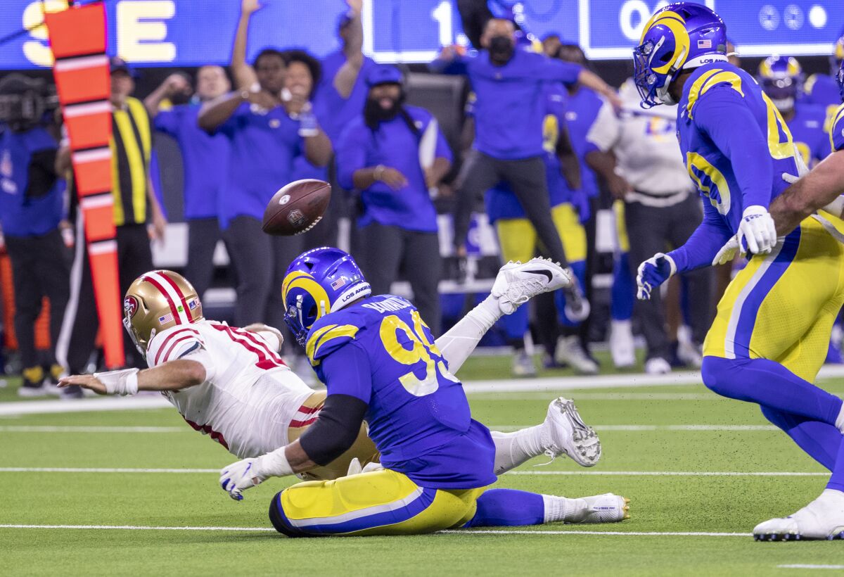 Pressure from Aaron Donald forces the 49ers' Jimmy Garoppolo to throw an interception.