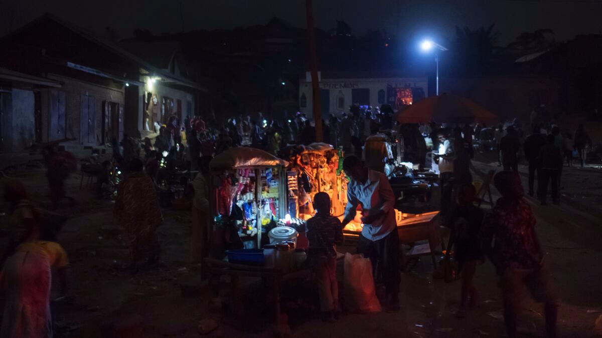 A night scene on July 14 at the market in Kanyabayonga, Congo, where many people have no access to electricity or suffer for frequent and long breakdowns. (Eduardo Soteras / AFP/Getty Images)