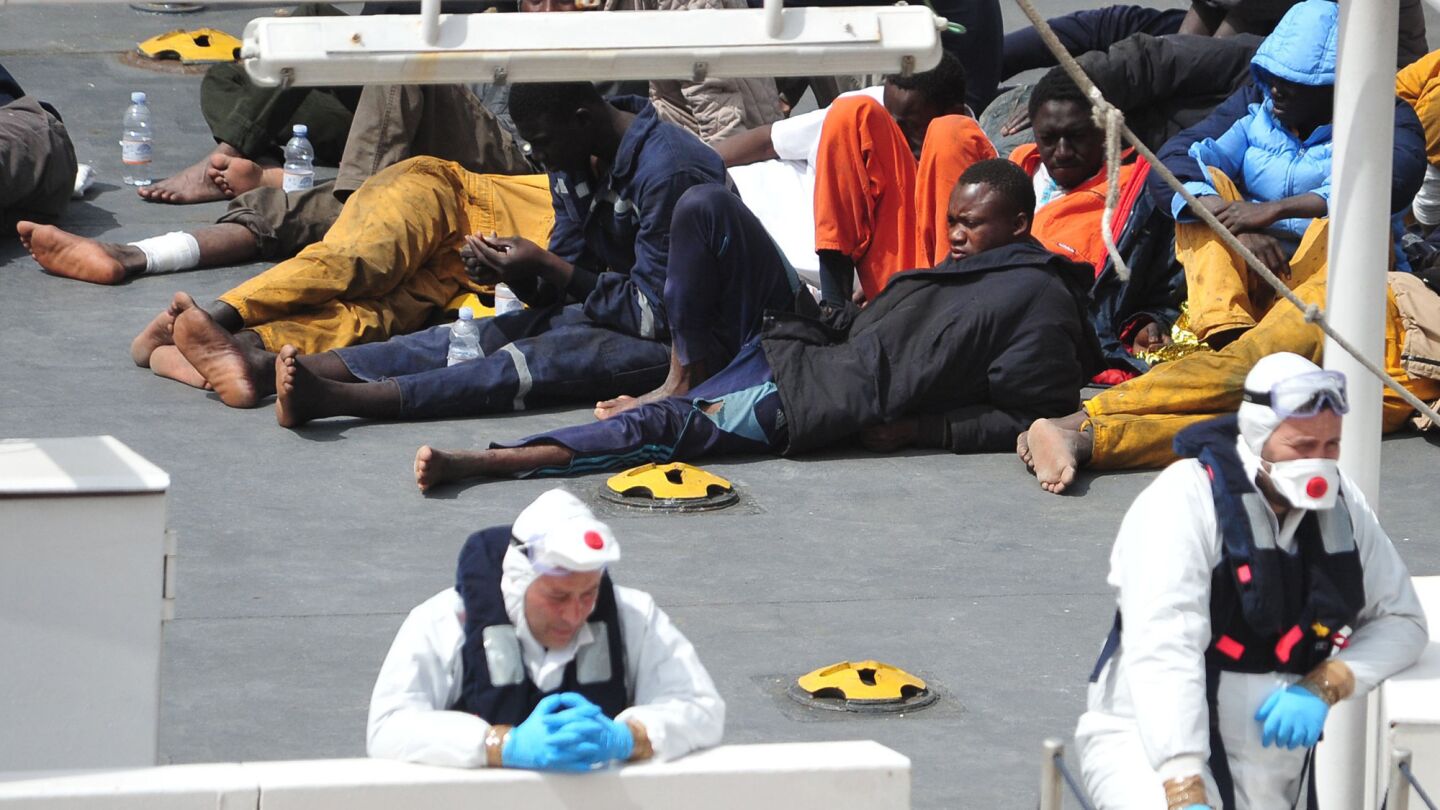 Survivors of the smuggler's boat that overturned off the coast of Libya lie on the deck of the Italian coast guard ship Bruno Gregoretti, in Valletta's Grand Harbour on Monday. A smuggler's boat crammed with hundreds of people overturned off Libya's coast on Saturday as rescuers approached, causing what could be the Mediterranean's deadliest known migrant tragedy and intensifying pressure on the European Union to finally meet demands for decisive action.