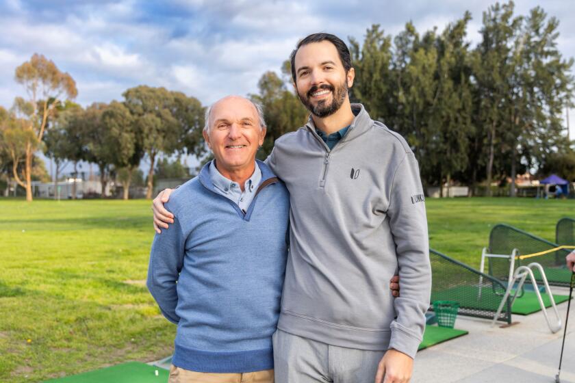 Jeremy Poincenot and his father, who serves as his caddy during major tournaments at Beyond Blindness event.
