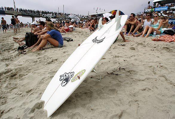 People wait on the beach for the women's final start Saturday at the U.S. Open of Surfing in Huntington Beach.