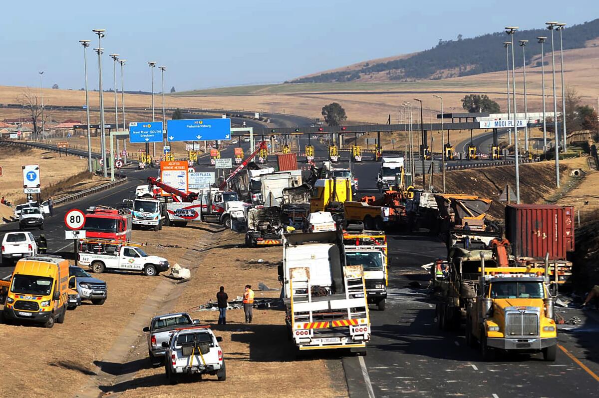 A section of a main freeway is blocked off by vehicles after trucks were set alight in overnight protests 