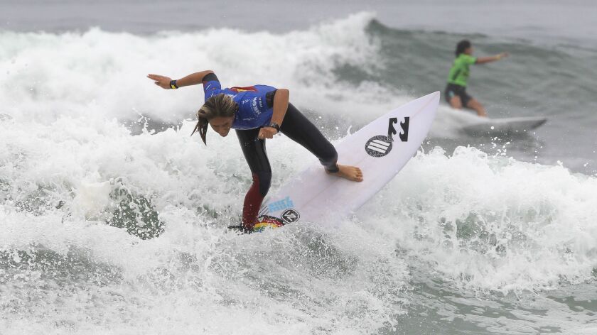 Zahli Kelly, left, from Australia, and Marissa Shaw, from the U.S., compete in their heat during the Supergirl Pro women's surfing competition in Oceanside on Friday.