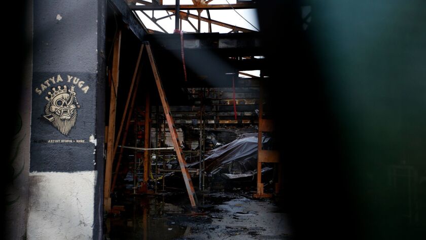 A 2016 file photo shows a view through the fence around the Ghost Ship warehouse in Oakland after the fire that killed 36 people.