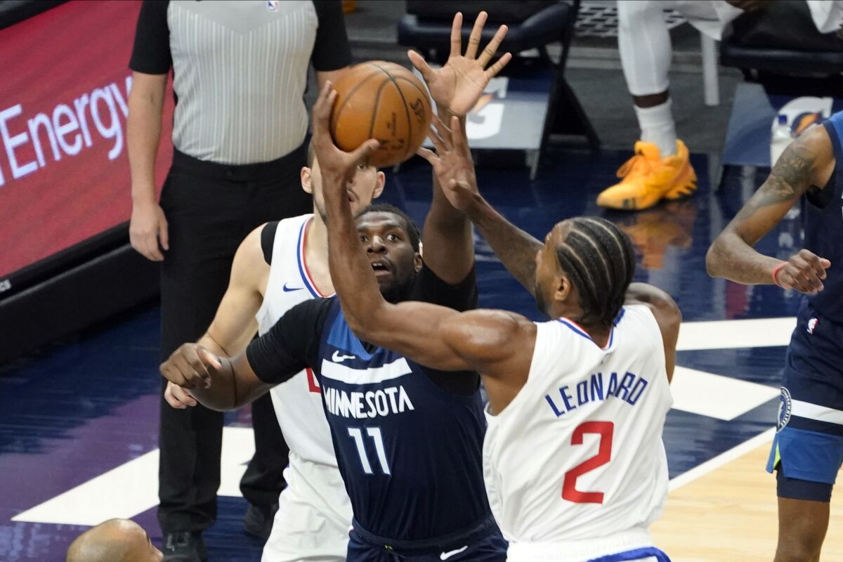 Minnesota Timberwolves' Naz Reid tries to block a shot by Clippers' Kawhi Leonard.