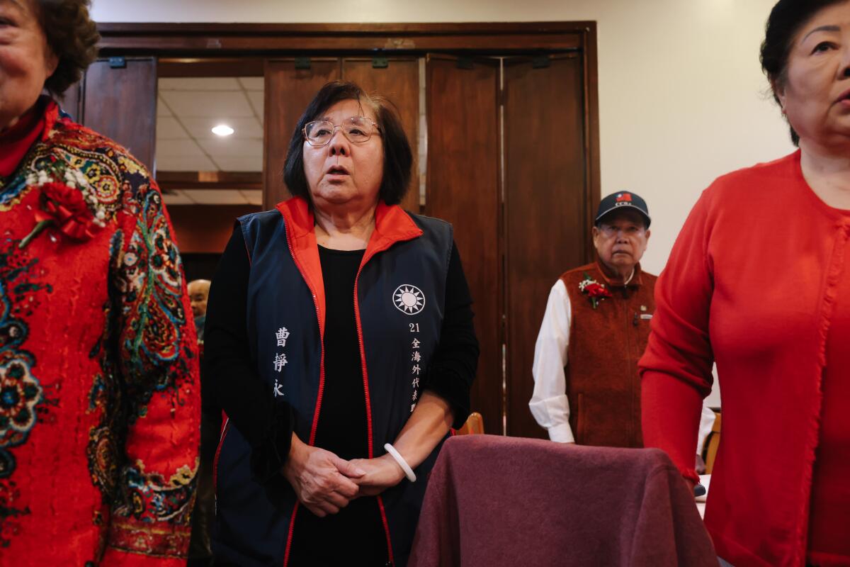 Jean Tsao, center, sings the national anthem at Chinatown's Golden Dragon Restaurant on Jan. 1 in Los Angeles.