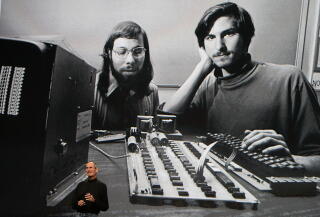 Apple Inc. CEO Steve Jobs speaks during an Apple Special Event in front of an early image of himself and Steve Wozniak