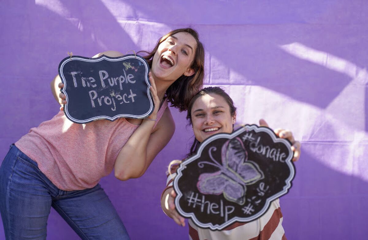 Founder Jordan Conole, right, and volunteer Amanda O'Donnell of The Purple Project, a charity targeting domestic violence.