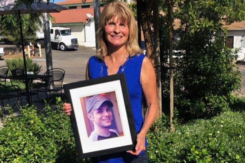 Ramona resident Lorraine Kerz holds a photo of her late son Silas "Sy" River Bennett 