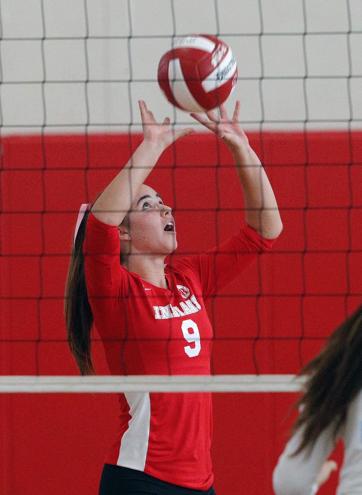 Burroughs' Meghan Lynch sets the ball for a kill against Crescenta Valley during Tuesday's Pacific League match.