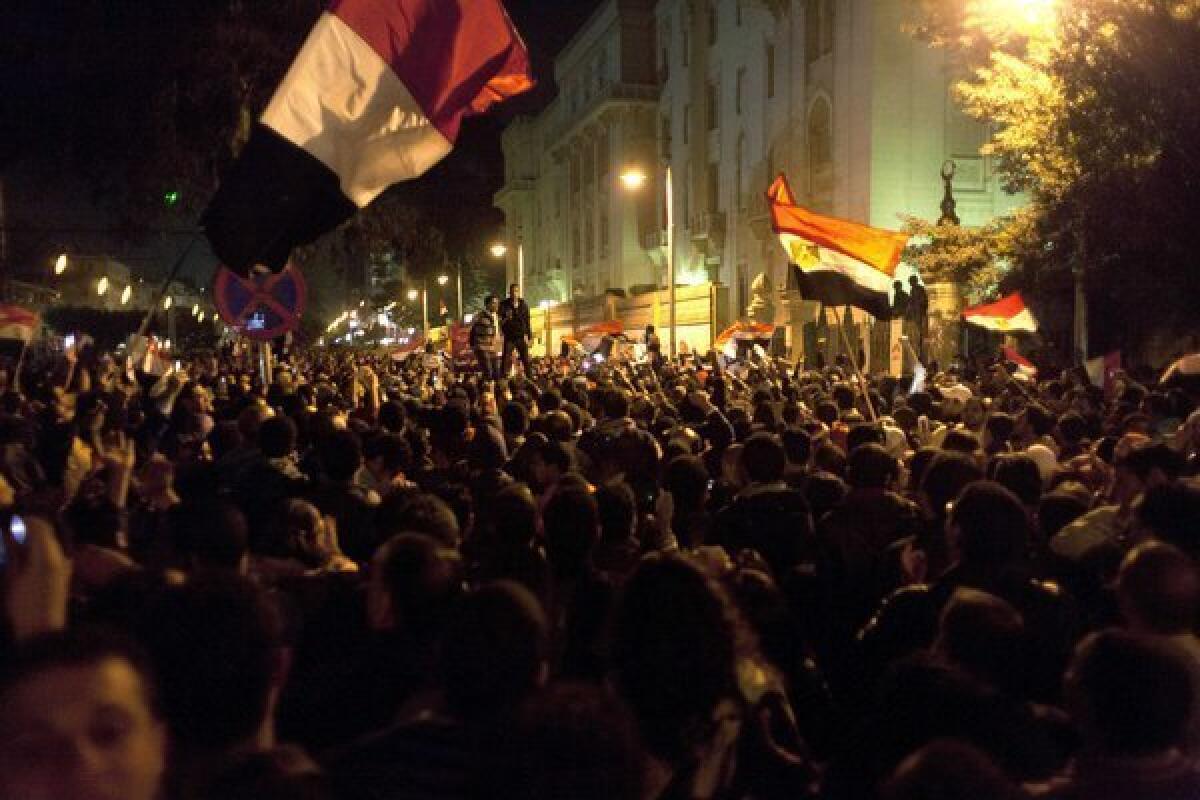 Protesters opposing Egyptian President Mohamed Morsi wave national flags and chant slogans during a demonstration in front of the presidential palace in Cairo.