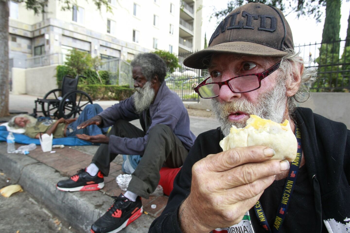 Michael Griffin, 67, who is homeless, eats an egg burrito given to him by Burrito Boyz in downtown San Diego.