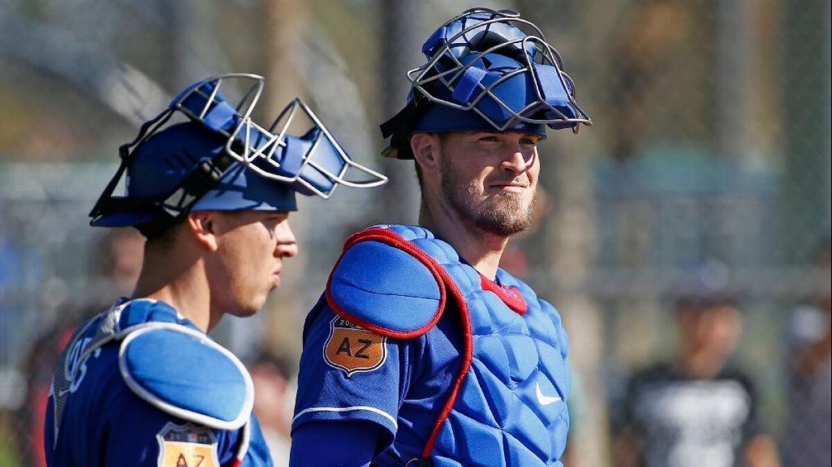 Dodgers catchers Yasmani Grandal and Austin Barnes pause at home plate during fielding drills at spring training on Feb. 21.