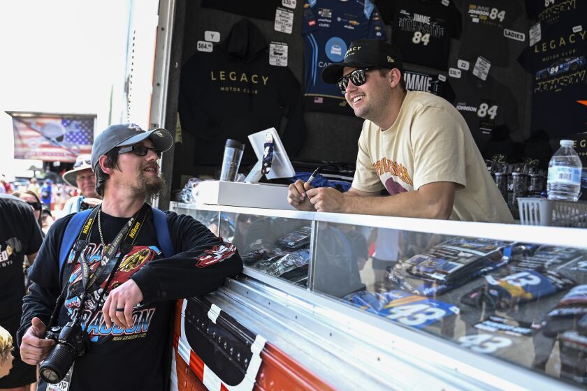 Noah Gragson, right, greets fans prior to the NASCAR All-Star Cup Series auto race at North Wilkesboro Speedway, Sunday, May 21, 2023, in North Wilkesboro, N.C. (AP Photo/Matt Kelley)