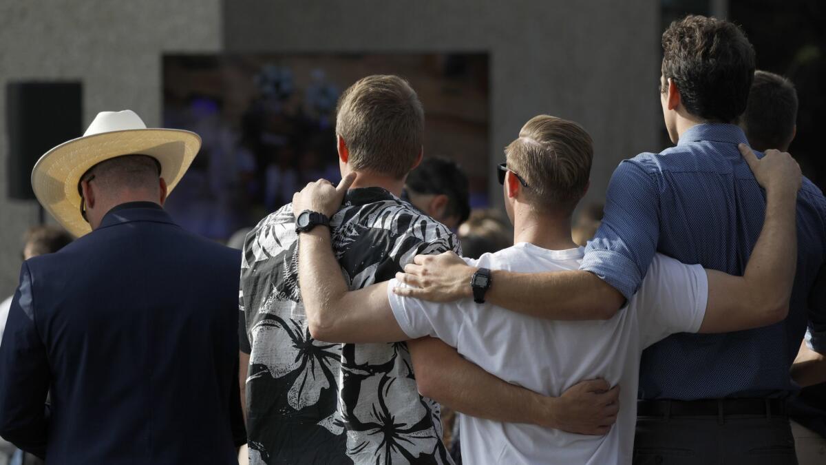 Friends and family gather at a memorial service for Justin Meek at Cal Lutheran University's Samuelson Chapel in Thousand Oaks.