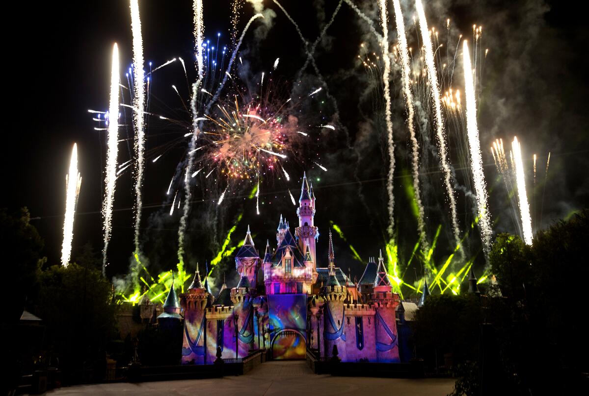 Fireworks shoot above Disneyland's castle