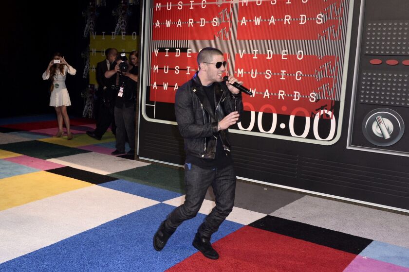 Nick Jonas performs on the red carpet for the 32nd MTV Video Music Awards.