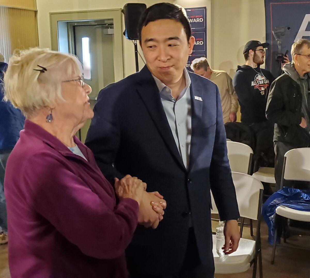 Andrew Yang meets with a supporter in Cedar Rapids, Ia.