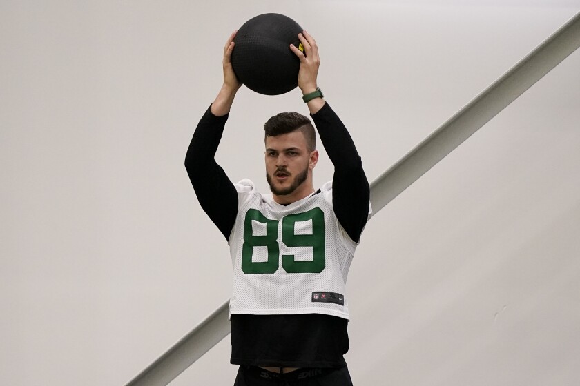 New York Jets' tight end Jeremy Ruckert (89) warms up with a medicine ball before the NFL football team's training camp, Friday, May 6, 2022, in Florham Park, N.J. (AP Photo/John Minchillo)