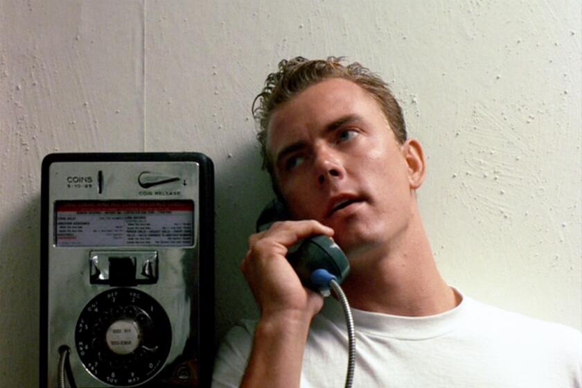 Barry Tubb, in white shirt at a payphone, as Lt. Leonard "Wolfman" Wolfe in "Top Gun"