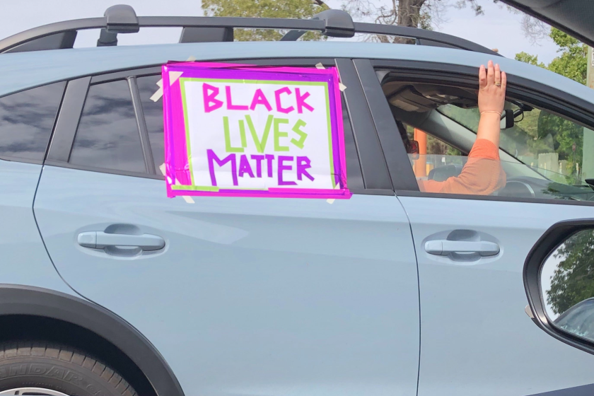 A car participates in a caravan protest in Oakland on Sunday.