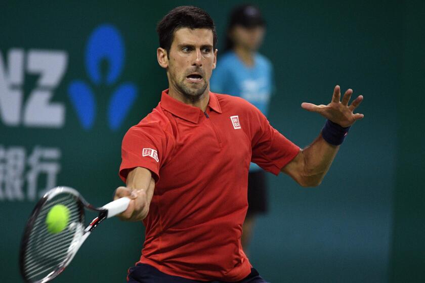 Novak Djokovic hits a return against Mischa Zverev during their men's singles match at the Shanghai Masters on Oct. 14.